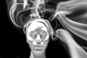 Manikin head surrounded by wisps of smoke
